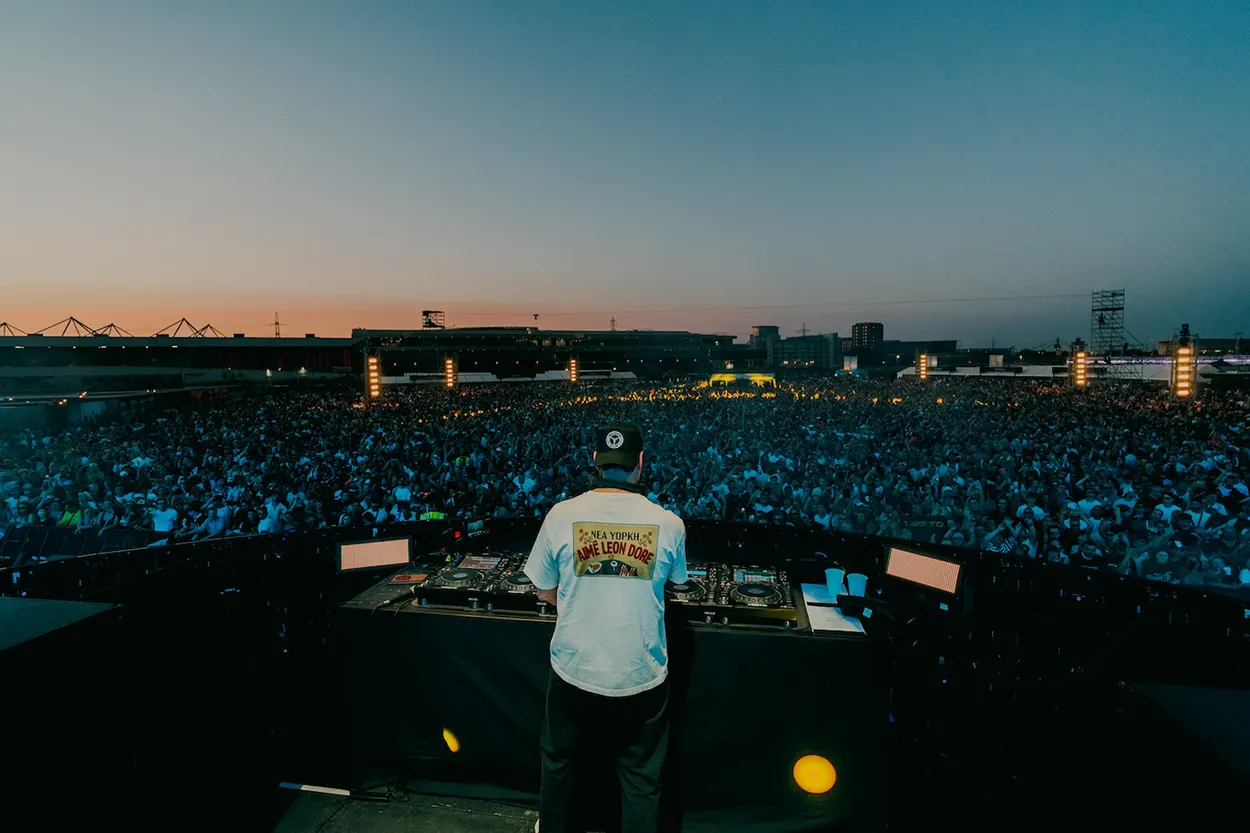 Tiësto joue face à une foule immense lors de son set à Silverworks Island en 2026, au coucher du soleil, derrière ses platines.